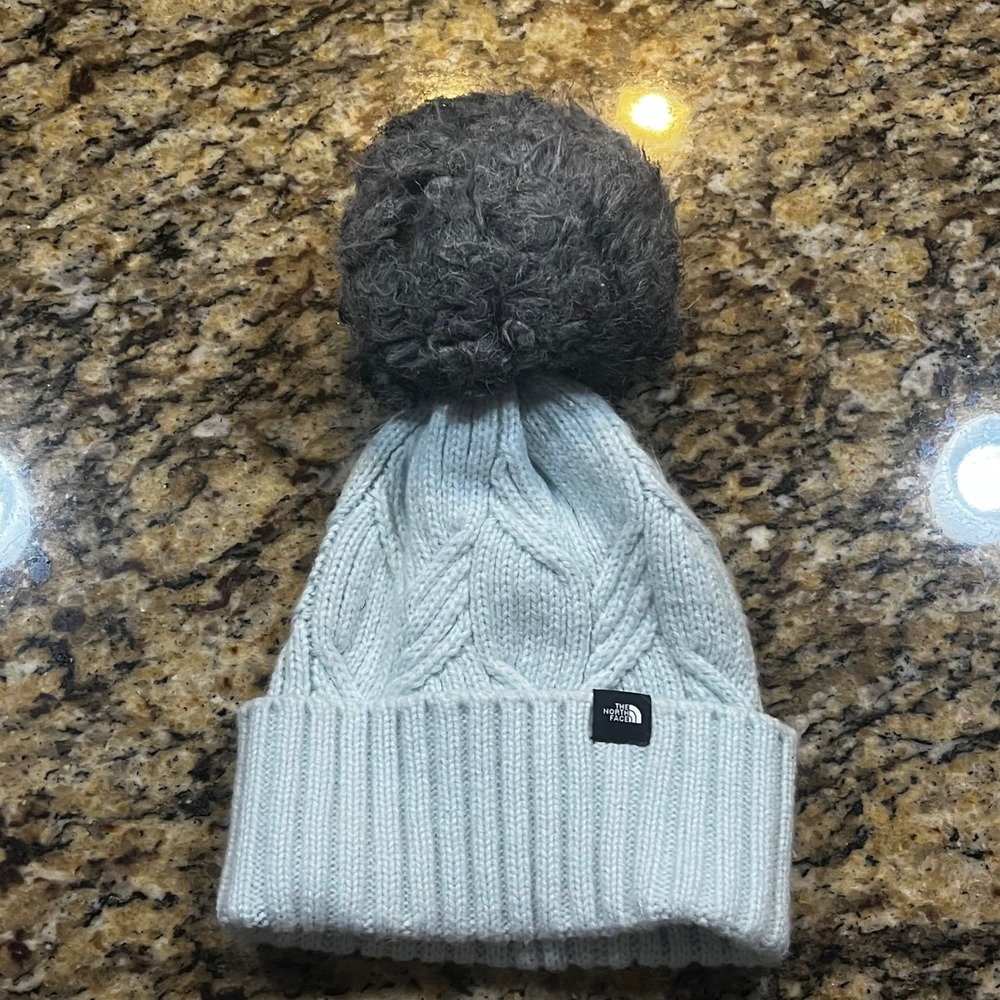 The North Face Youth Oh-Mega Fur Pom Beanie Light Blue Cable Knit Hat One Size